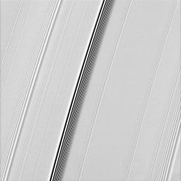 NASA's Cassini spacecraft spies two types of waves in Saturn's A ring: a spiral density wave on the left of the image and a more pronounced spiral bending wave near the middle.