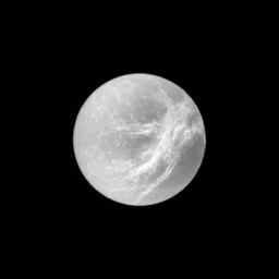 Appearing like the swirls of marble, the wispy terrain of Saturn's moon Dione is captured by NASA's Cassini spacecraft in a dramatic display of light and dark. These wispy features are a system of braided canyons with bright walls.