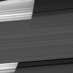 The limb of Saturn appears bright as NASA's Cassini spacecraft peers through several of the planet's rings. The curvature of the planet can be seen on the bright left half of the image.