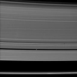Saturn's small moon Pan casts a long shadow across the A ring in this image captured by NASA's Cassini spacecraft a few days after the planet's August 2009 equinox.