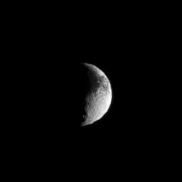 Light and dark terrain covers the surface of Saturn's moon Iapetus in this view from NASA's Cassini spacecraft.