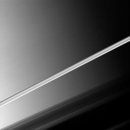 Saturn's brightly lit rings slice across this NASA Cassini spacecraft picture taken before a backdrop of the planet's clouds.