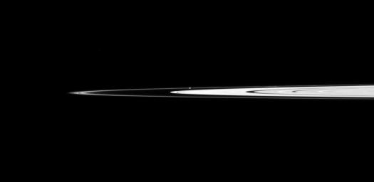 Saturn's small, potato-shaped moon Prometheus orbits between the main rings and the thin F ring in this view captured by NASA's Cassini spacecraft.
