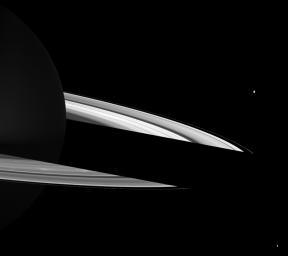 Bright spokes can be seen on Saturn's B ring just in front of the shadow cast on the rings on the night side of the planet in this NASA Cassini spacecraft image.
