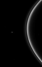 NASA's Cassini spacecraft watches Pandora, one of the F ring's two shepherding moons, orbiting beyond the thin ring; the small moon can be seen on the left of this image.