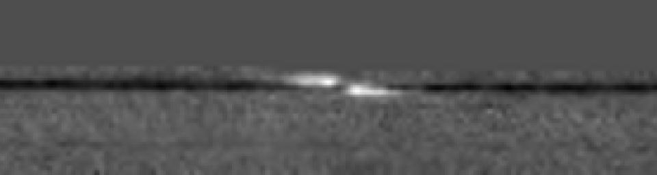 NASA's Cassini spacecraft captured a propeller-shaped disturbance in one of Saturn's rings created by a moon that is too small to be seen here. The moon is invisible at the center of the image.