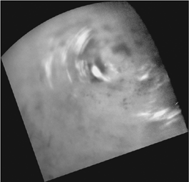 Clouds move above Titan's large methane lakes and seas near the moon's north pole in this image from NASA's Cassini spacecraft. Methane clouds in the troposphere, the lowest part of the atmosphere, appear white here.