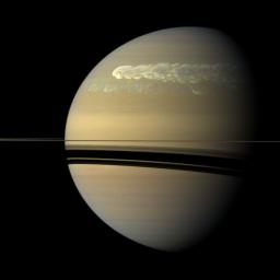 A huge storm churning through the atmosphere in Saturn's northern hemisphere overtakes itself as it encircles the planet in this true-color view from NASA's Cassini spacecraft.