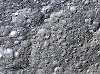 This perspective view from NASA's Cassini orbiter shows the western half of Rhea's second largest impact basin, Tirawa. The broad arcuate scarp cutting across scene center is the battered rim of Tirawa.