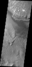 Melas Chasma is the central portion of Valles Marineris. This image taken by NASA's 2001 Mars Odyssey shows a small portion of the floor of Melas Chasma, including layered deposits and wind eroded and deposited materials.