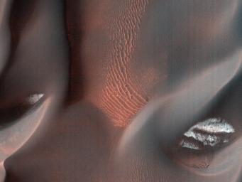 This image captured by NASA's Mars Reconnaissance Orbiter shows the edge of a dark dune field on the floor of Proctor Crater, a 150 kilometer diameter crater in the southern highlands of Mars.