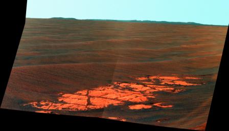 NASA's Mars Exploration Rover Opportunity used its panoramic camera (Pancam) to capture this false-color view of the rim of Endeavour crater, the rover's destination in a multi-year traverse along the sandy Martian landscape.