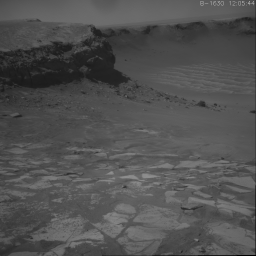 This image shows NASA's Opportunity's climb out of Victoria crater. It is the first frame of a movie that spans three days when the rover exited the crater at the alcove called 'Duck Bay' leaving two sets of wheel tracks.