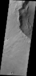 This image captured by NASA's 2001 Mars Odyssey shows a landslide deposit located in an unnamed crater in Syrtis Planum.