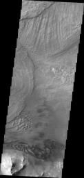 Large landslide deposits dominate this image of Ius Chasma captured by NASA's 2001 Mars Odyssey. Dunes are visible at the bottom of the frame.
