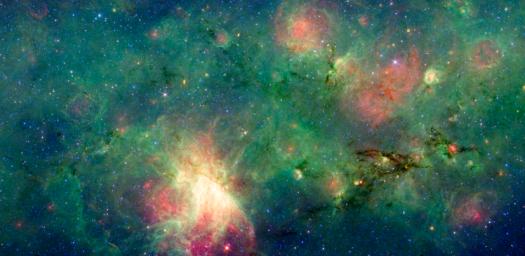 A dragon-shaped cloud of dust seems to fly out from a bright explosion in this infrared light image from NASA's Spitzer Space Telescope. These views have revealed that this dark cloud, called M17 SWex, is forming stars at a furious rate.