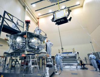 Technicians lowered a special radiation vault onto the propulsion module of NASA's Juno spacecraft. The vault will dramatically slow the aging effect radiation has on the electronics for the duration of the mission.