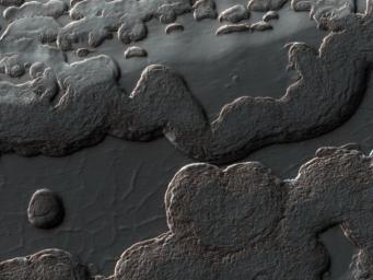 This image from NASA's Mars Reconnaissance Orbiter shows a variety of surface textures within the south polar residual cap of Mars. It was taken during the southern spring, when the surface was covered by seasonal carbon dioxide frost and is easily seen.