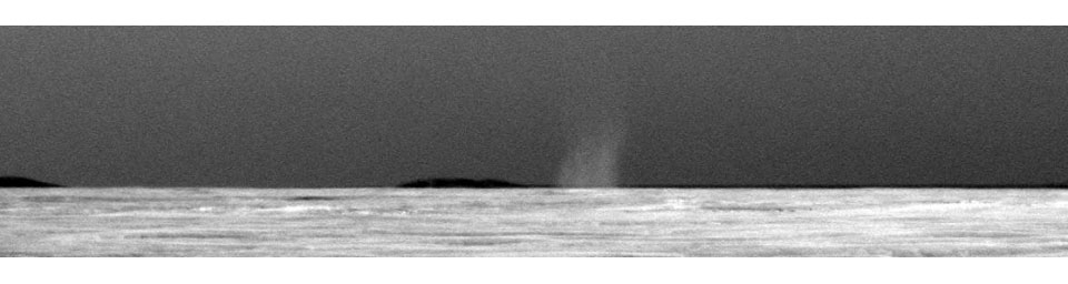 This is the first dust devil that NASA's rover Opportunity has observed in the rover's six and a half years on Mars. This image has been carefully calibrated and the contrast stretched to make the dust devil easier to see against the Martian sky.