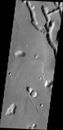 What appear to be channels in this image from NASA's Mars Odyssey is the dissection of the higher elevations on the margin of Chryse Chaos. Continued dissection eventually creates the block/mesa forms termed chaos on Mars.