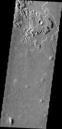 This wind eroded crater is located between Eumenides and Gordii Dorsa. The ejecta of the crater is more resistant to the wind than the surrounding materials in this image from NASA's Mars Odyssey.