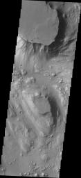 Located at the eastern end of Vallis Marineris is the region of chaos called Aurorae. This image from NASA's Mars Odyssey is from the northern part of Aurorae Chaos and contains mesas separated by complex low lying regions.