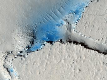 This observation from NASA's Mars Reconnaissance Orbiter shows fractured mounds on the southern edge of Elysium Planitia. The fractures that crisscross their surfaces are probably composed of solidified lava.