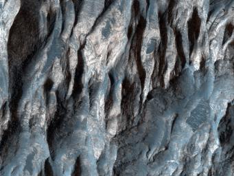 In this image from NASA's Mars Reconnaissance Orbiter, there are at least two distinct geologic units, a light-toned bedrock and a surface veneer of dark-toned material that contains sand dunes.