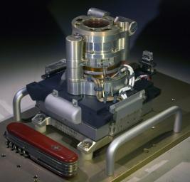 The Mars Hand Lens Imager (MAHLI) camera will fly on NASA's Mars Science Laboratory mission, launching in late 2011. This photo of the camera was taken before MAHLI's November 2010 installation onto the robotic arm of the mission's Mars rover, Curiosity.