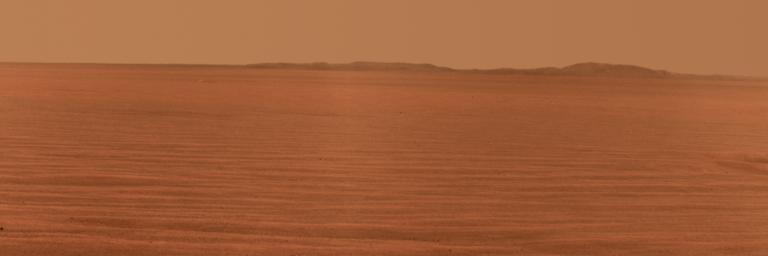 NASA's Mars Exploration Rover Opportunity used its panoramic camera to record this eastward horizon view. A portion of Endeavour Crater's eastern rim, in the distance, is visible over the Meridiani plain.
