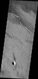 The channel seen in this image from NASA's Mars Odyssey is located within the Tharsis volcanic flows. It was most likely carved by the flow of molten lava.