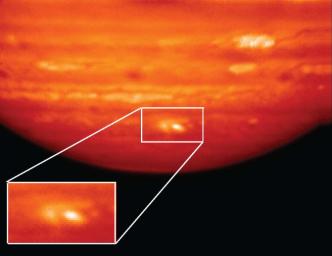 This infrared image, showing thermal radiation at a wavelength of 9.7 microns, was obtained by the Gemini North Telescope in Hawaii. The bright white and yellow features at bottom are the aftermath of an impactor hitting Jupiter on July 19, 2009.