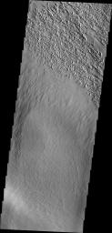 The pits at the top of this image are created by the action of the wind in this image captured by NASA's Mars Odyssey.