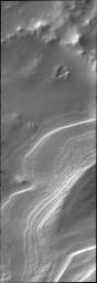 Layering in south polar ice is easy to see in this outlier of the main polar cap. This image was captured by NASA's Mars Odyssey.
