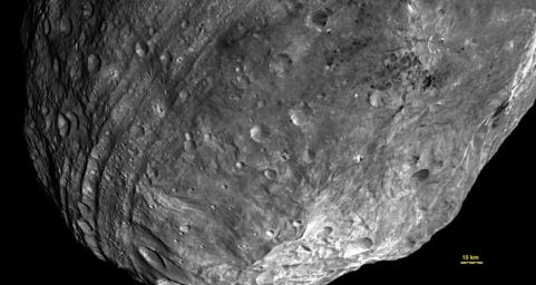 This image, obtained by the framing camera on NASA's Dawn spacecraft, a peak at Vesta's south pole is seen at the lower right. The grooves in the equatorial region are about six miles wide.