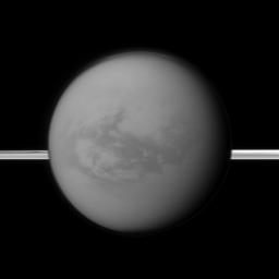 Saturn's rings lie in the distance as NASA's Cassini spacecraft looks toward Titan and its dark region called Shangri-La, east of the landing site of the Huygens Probe.