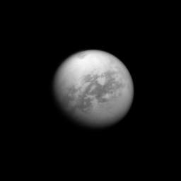 NASA's Cassini spacecraft looks toward Saturn's largest moon, Titan, and spies the huge Kraken Mare in the moon's north. Kraken Mare, a large sea of liquid hydrocarbons, is visible as a dark area near the top of the image.