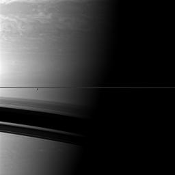 A pair of Saturn's moons appear insignificant compared to the immensity of the planet. Enceladus is at left, Epimetheus appears as a tiny black speck on the far left in this image from NASA's Cassini spacecraft.