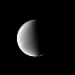 Titan's south polar vortex seems to float above the moon's south pole in this Cassini spacecraft view. The vortex, which is a mass of gas swirling around the south pole high in the moon's atmosphere, can be seen in the lower right of this view.