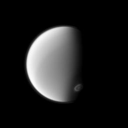 NASA's Cassini spacecraft spies Titan's south polar vortex from below the moon in this image. Imaging scientists are monitoring the vortex to study its seasonal development.