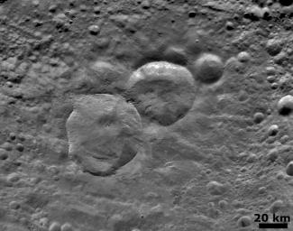 This image from NASA's Dawn spacecraft shows a detailed view of three craters, informally nicknamed 'Snowman' by the camera's team members.