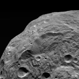 NASA's Dawn spacecraft obtained this image of the giant asteroid Vesta with its framing camera on Aug. 26, 2011. The detail in this image shows a steep scarp with landslides and vertical craters in the scarp wall. 