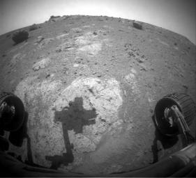 The robotic arm of NASA's Mars Exploration Rover Opportunity casts a shadow on a rock outcrop called 'Chester Lake.' The rock is on a low ridge called 'Cape York,' which is a segment of the western rim of Endeavour crater.
