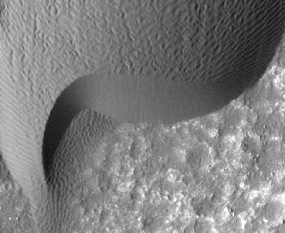 A rippled dune front in Herschel Crater on Mars moved an average of about two meters (about two yards) between March 3, 2007 and December 1, 2010, as seen in one of two images from NASA's Mars Reconnaissance Orbiter.