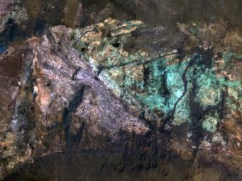 The colorful rocks exposed in the central peak visible in this image from NASA's Mars Reconnaissance Orbiter probably reflect variations in mineral content that were caused by water activity early in Mars' history.