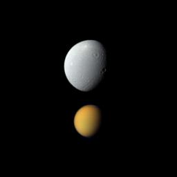 Saturn's largest moon, Titan, appears deceptively small paired here with Dione, Saturn's fourth-largest moon, in this view from NASA's Cassini spacecraft.