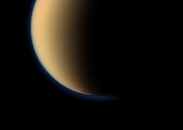 This view from NASA's Cassini spacecraft look toward the south polar region of Saturn's largest moon, Titan, and show a depression within the moon's orange and blue haze layers near the south pole.