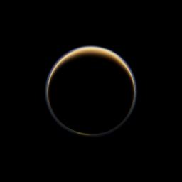 NASA's Cassini spacecraft looks toward the night side of Saturn's largest moon and sees sunlight scattering through the periphery of Titan's atmosphere and forming a ring of color.