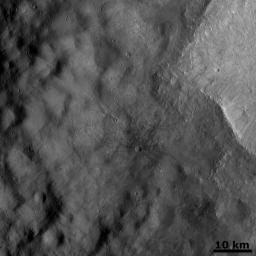 The crater on asteroid Vesta shown in this image from NASA's Dawn spacecraft was emplaced onto the ejecta blanket of two large twin craters. Commonly, rays from impact craters are brighter than the surrounding surface.
