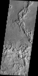 Mesas and valleys form the terrain called Margaritifer Chaos as shown in this image captured by NASA's 2001 Mars Odyssey spacecraft.